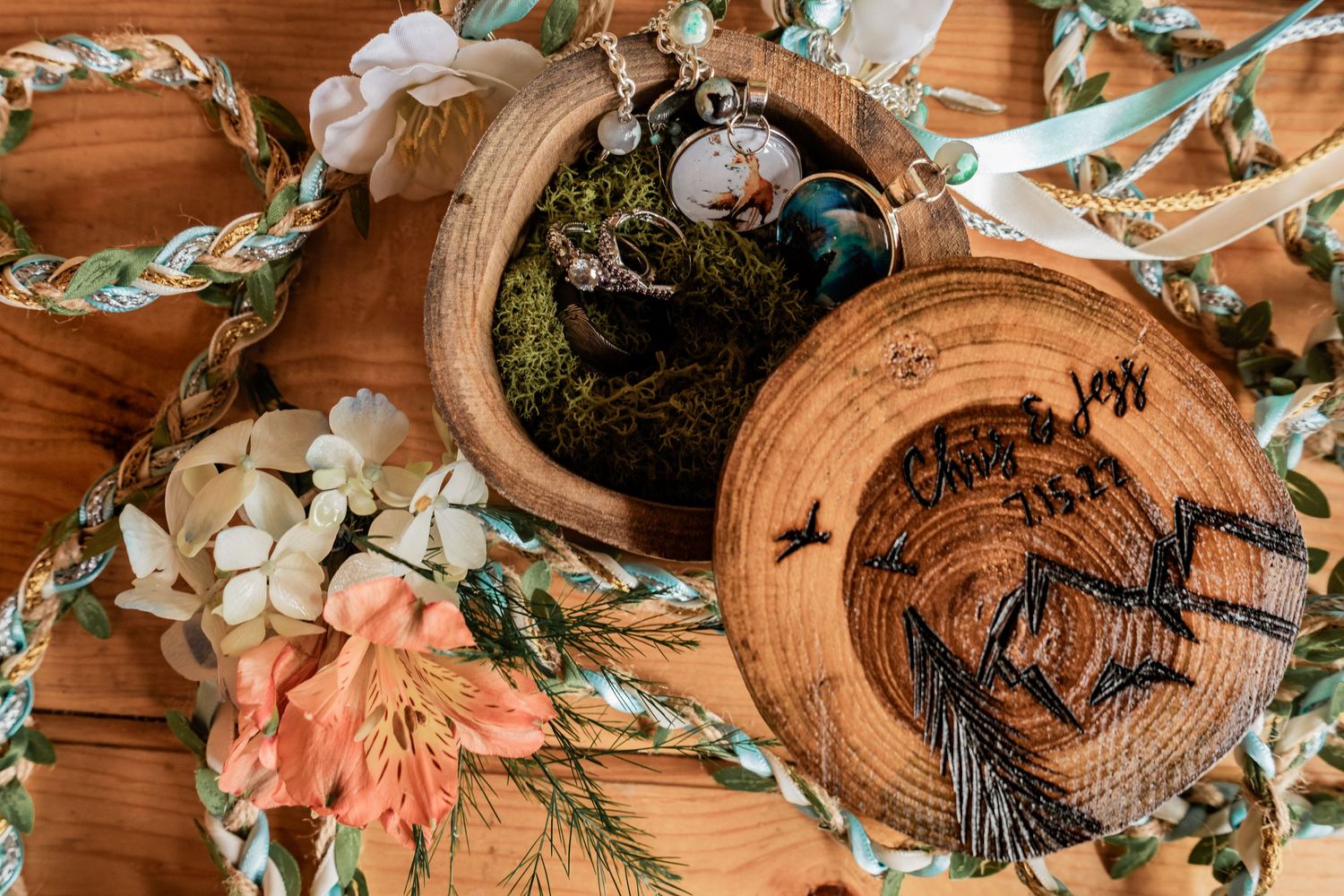 Rustic wooden decor featuring floral arrangements and carved decorative pieces on a wooden surface.