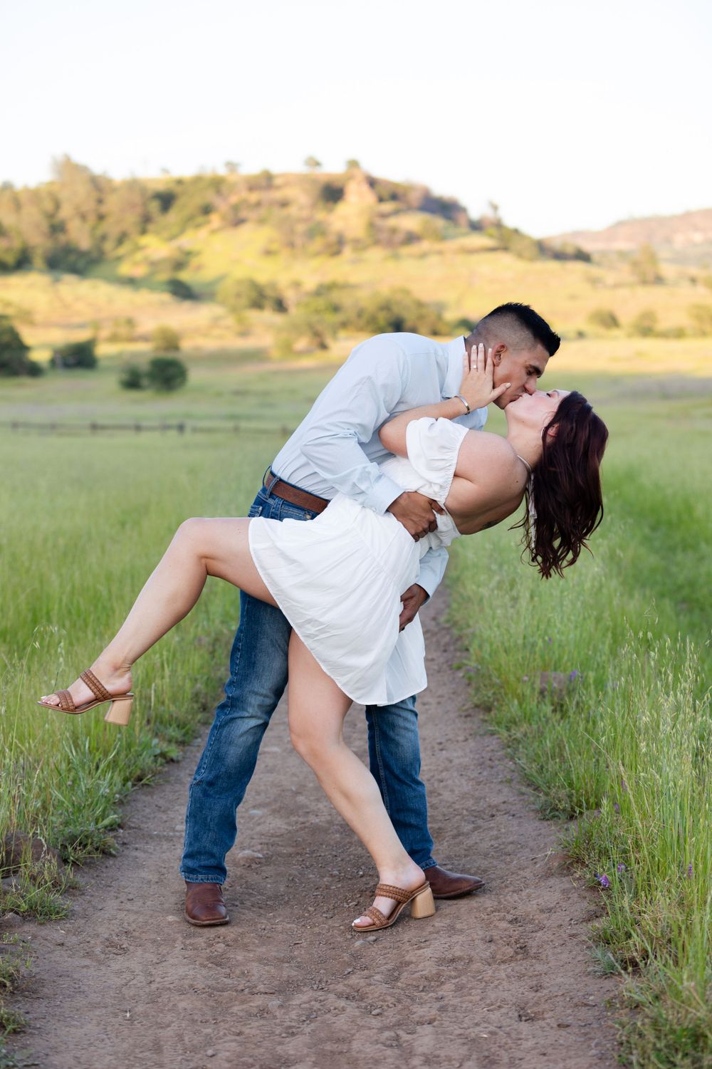 Engagement session in upper park, bidwell park, Chico, California with green grass and hills in the background