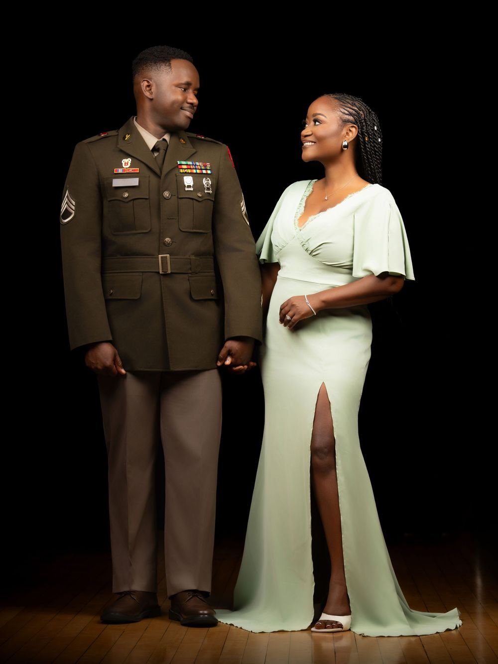A couple in formal attire poses for a series of romantic wedding photos with one in military dress uniform.