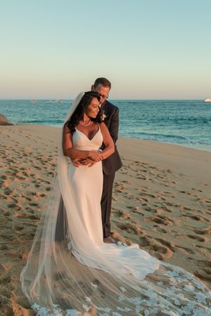 Bride and groom holding hands during sunset session