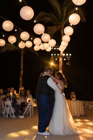 Wedding guests celebrating on beach in Cabo