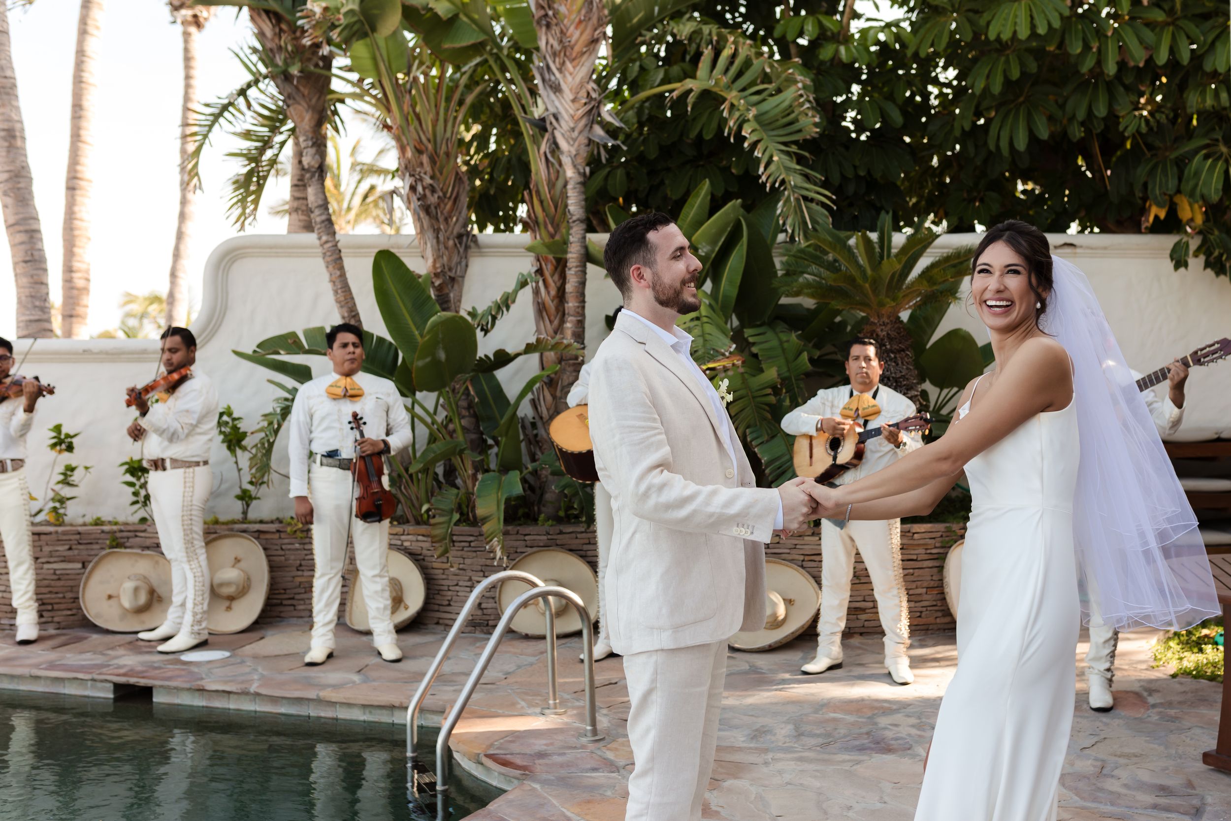 Bride and groom holding hands during sunset session