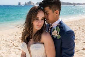Groom adjusting suit before ceremony in Cabo