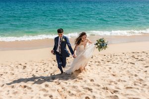 Couple celebrating love in beach wedding session