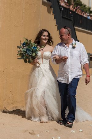 Bride holding bouquet during beach wedding in Los Cabos