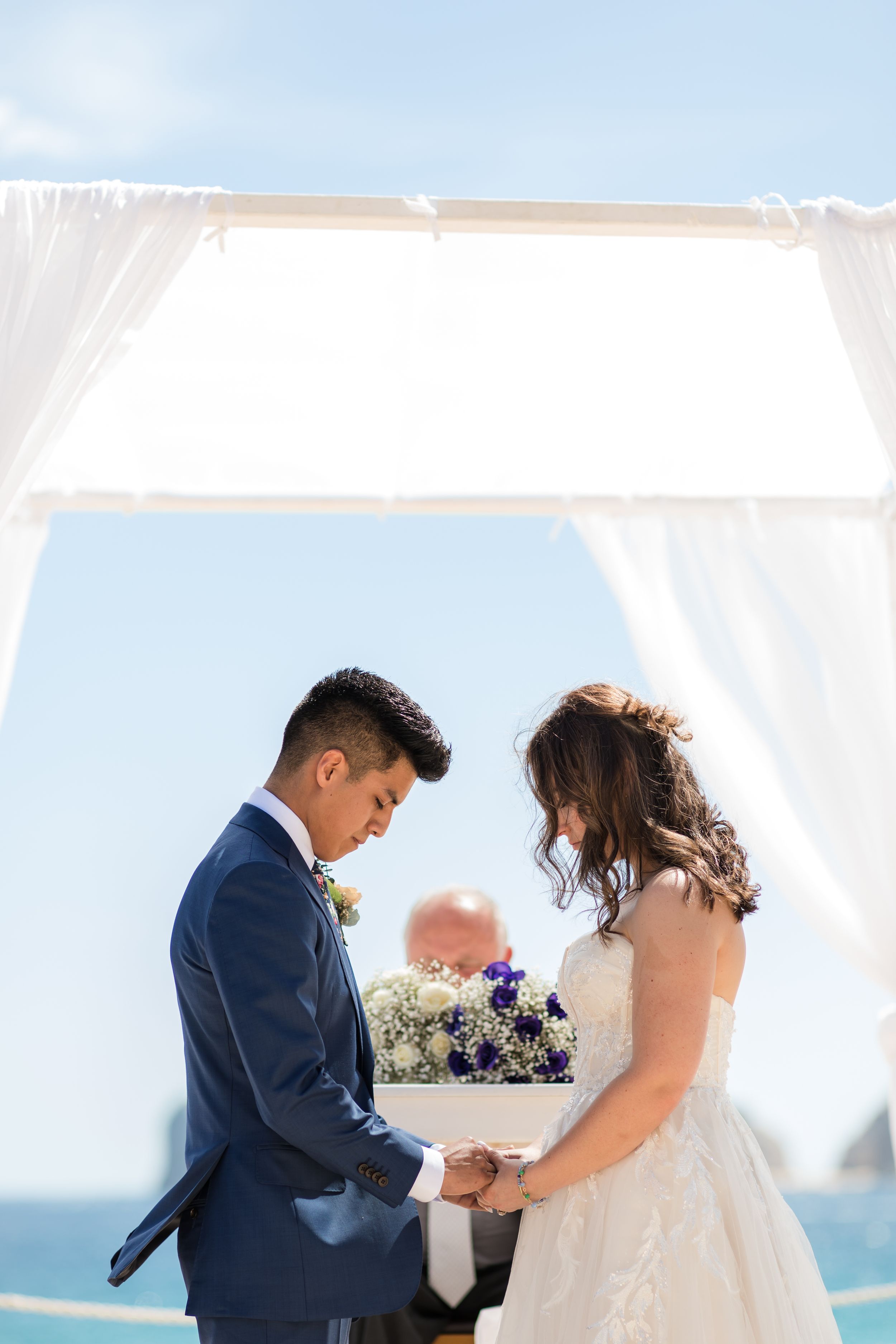 Groom adjusting tie before ceremony in Cabo