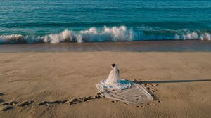 Elegant bride walking on the beach in San José del Cabo