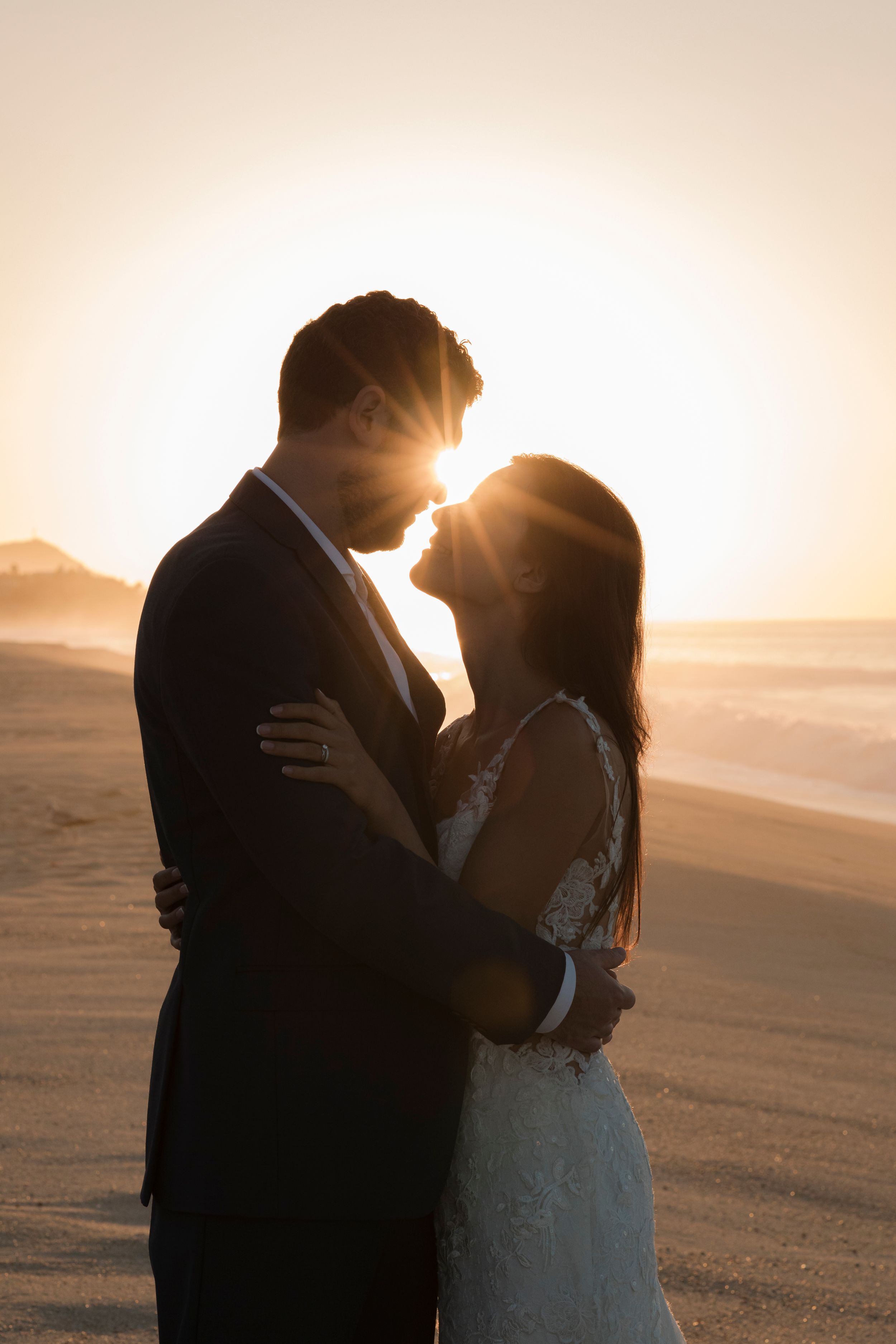 Bride and groom holding hands during sunset session