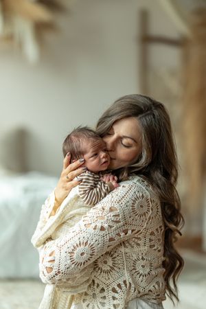 A tender moment captured in soft light with a cozy cream knit sweater.