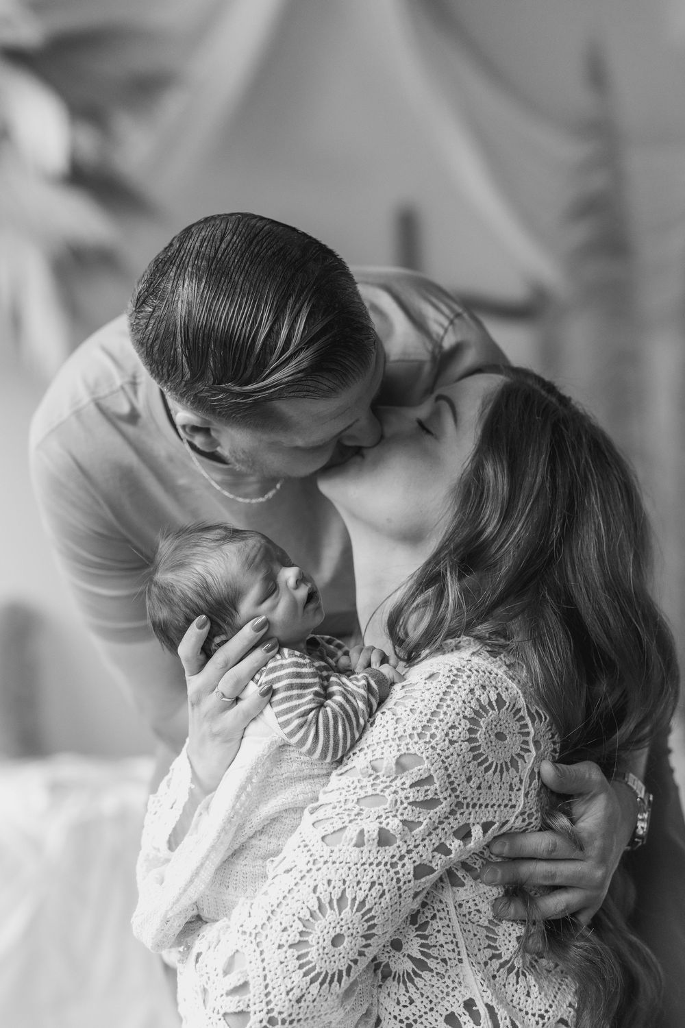 A series of intimate black and white photos showing tender embraces and emotional moments.