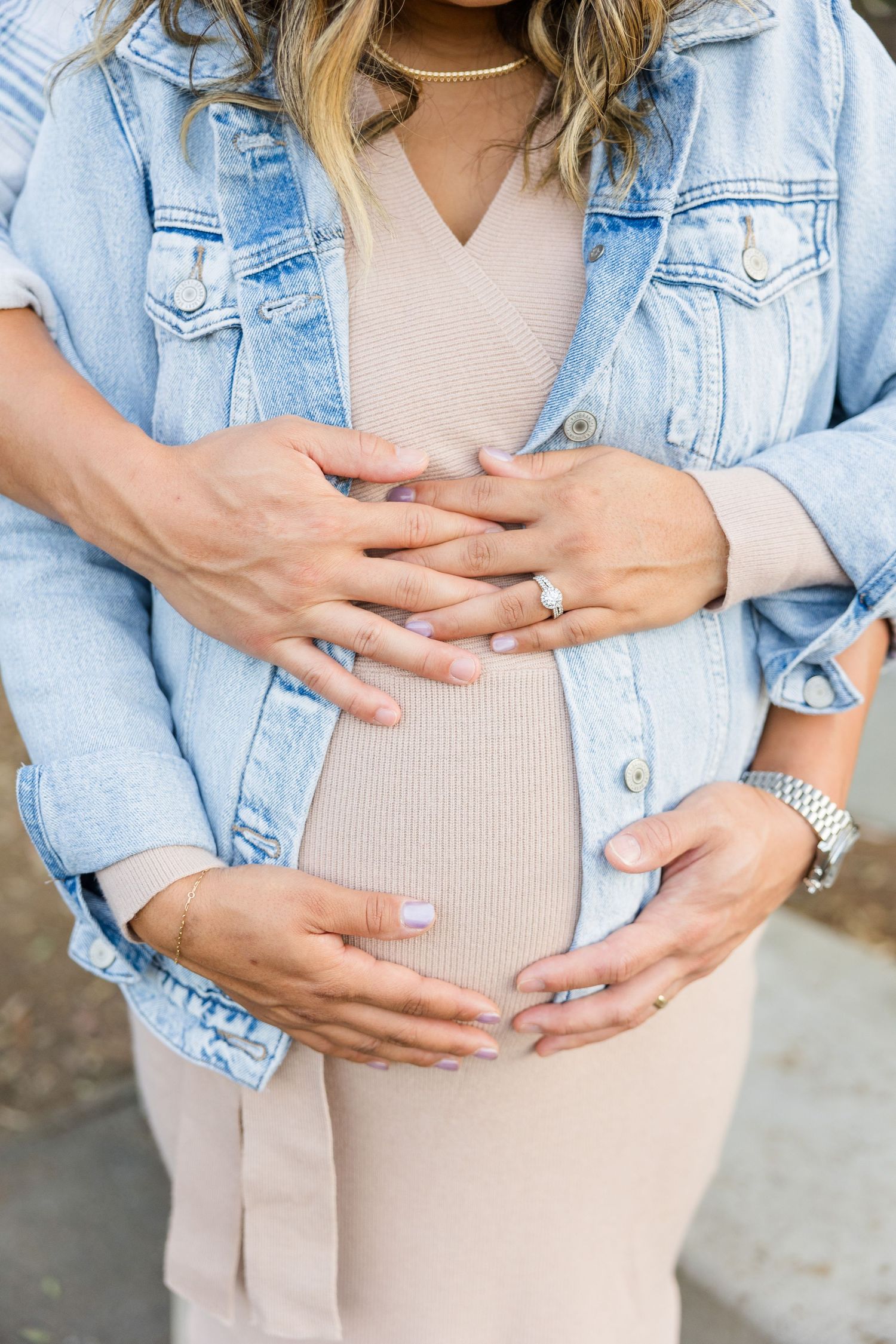Maternity session with mom and dad's hands on the belly in Huntington Beach