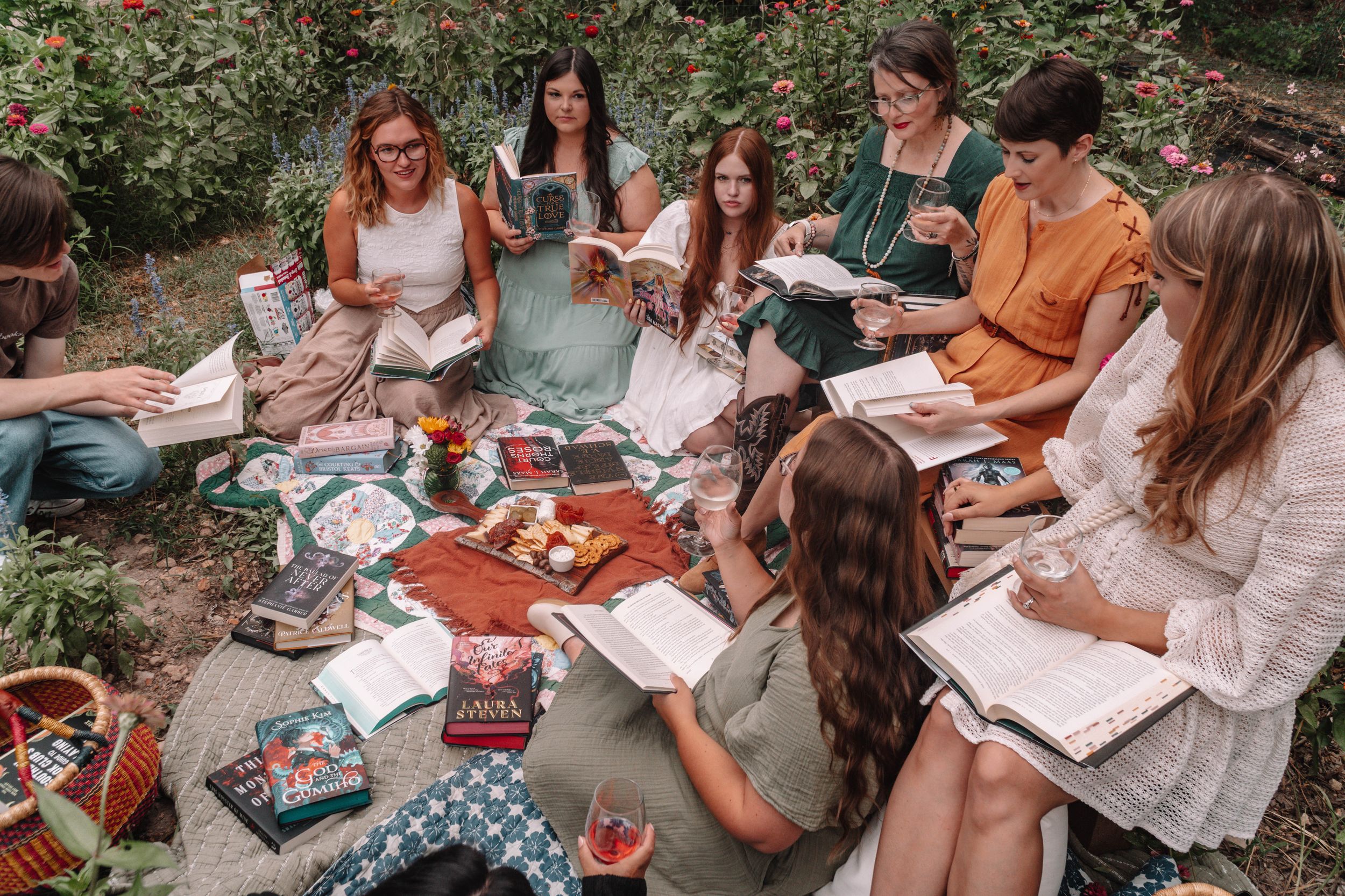 Group of people gathered outdoors for a book club meeting.