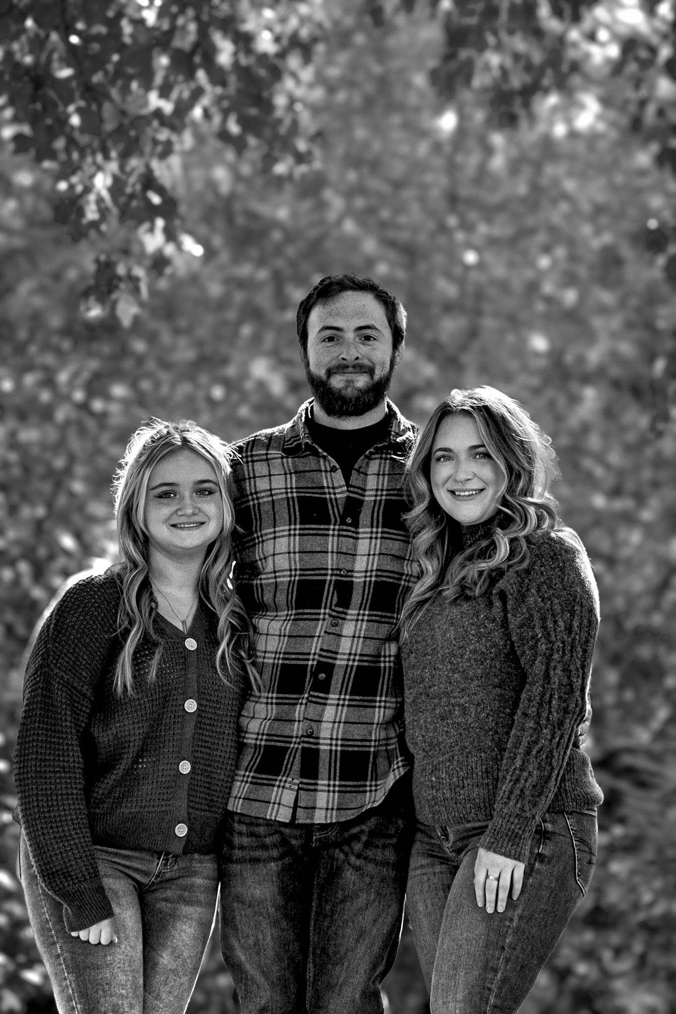 Black and white portrait series showing casual family interactions outdoors.