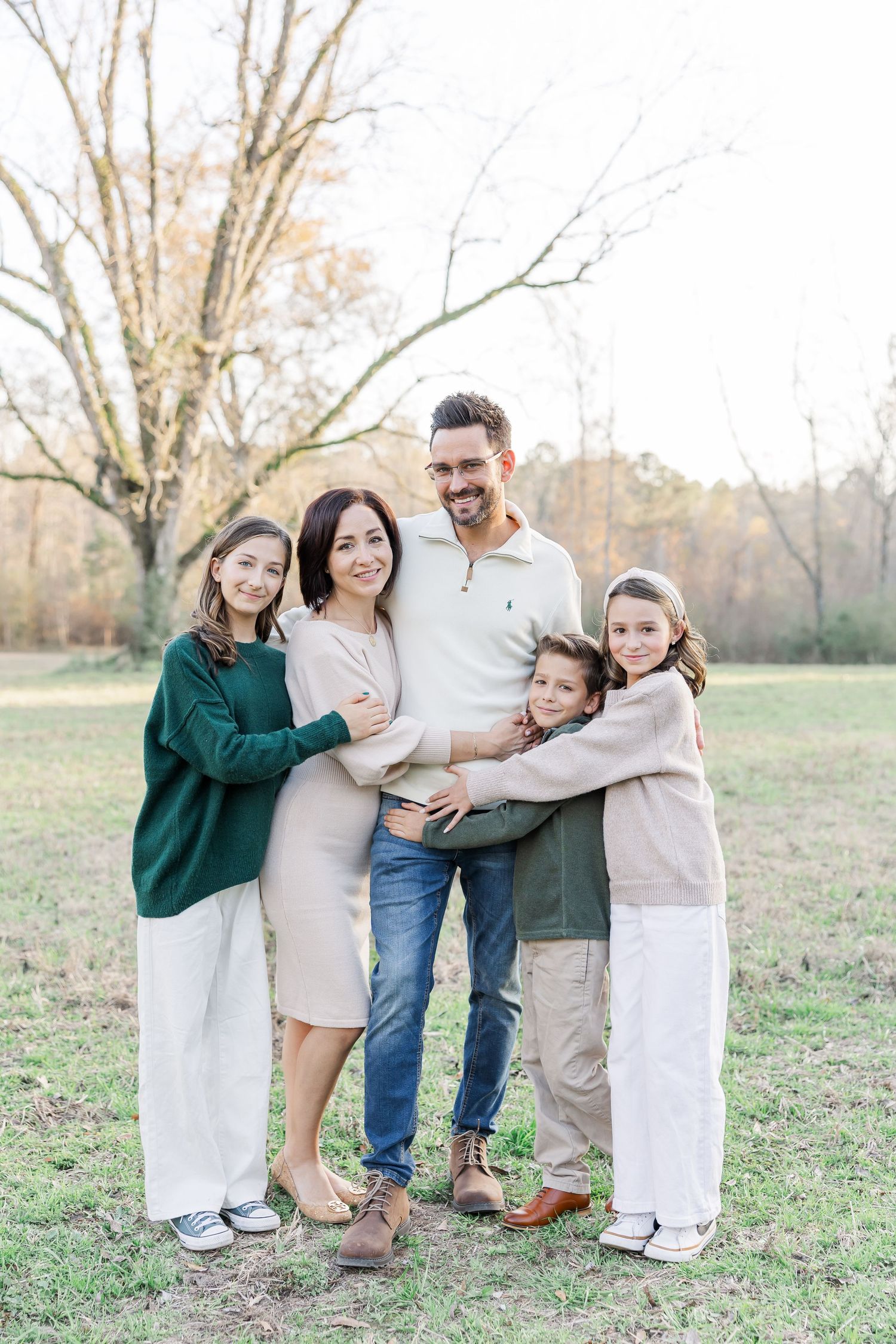 Family smiling natural and hugging each other for family session