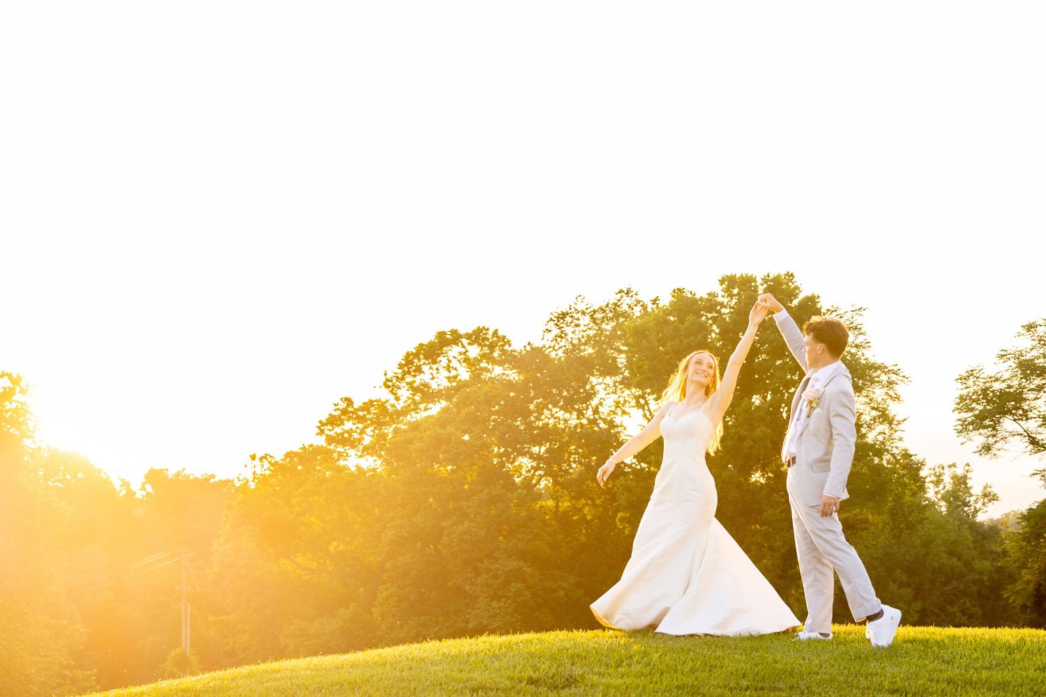 A bride and groom embrace in a garden setting with blooming flowers.