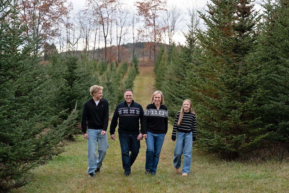Family of four, family portrait outdoors in Port Hope, Ontario at a Christmas tree Farm*