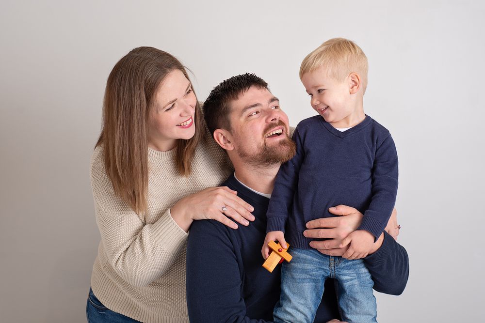 Happy family of 3 with young son interacting with each other during an in studio photo session near Cobourg Ontario*