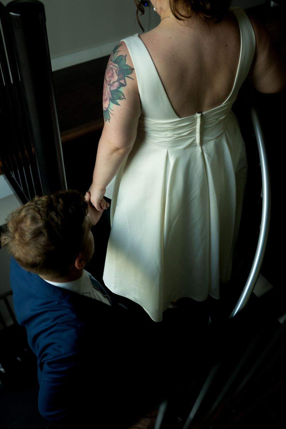 Back view of a white dress showing delicate details and straps.