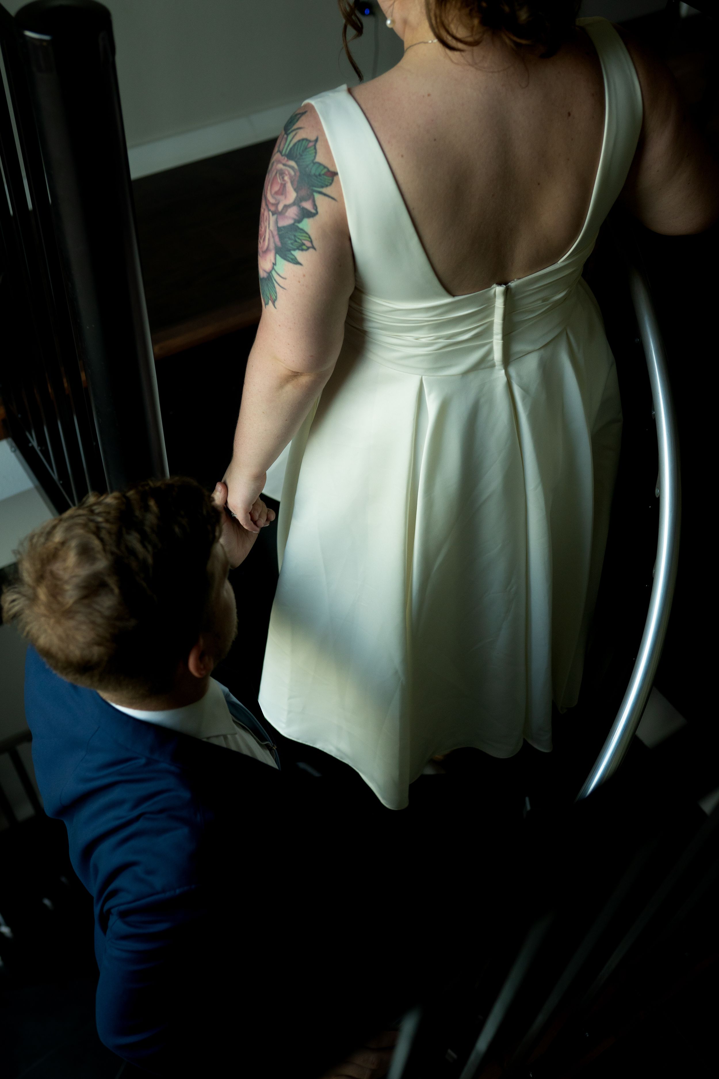 Back view of a white dress showing delicate details and straps.