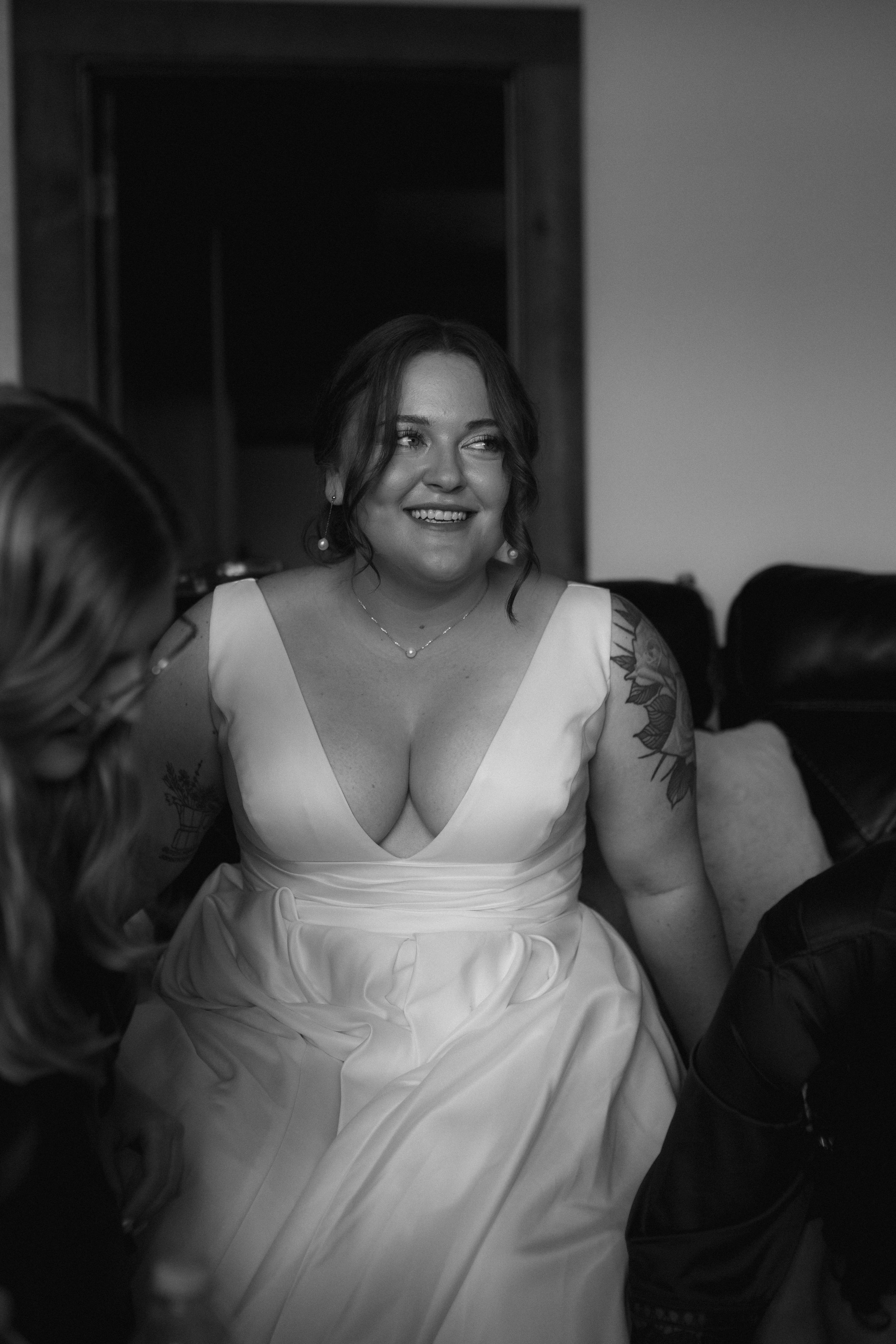 Black and white portrait of bride smiling in white wedding dress.