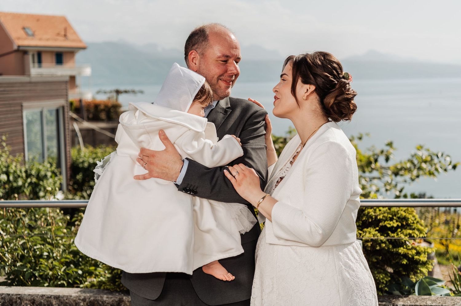 Bride and groom share joyful laughter during their outdoor wedding photoshoot.