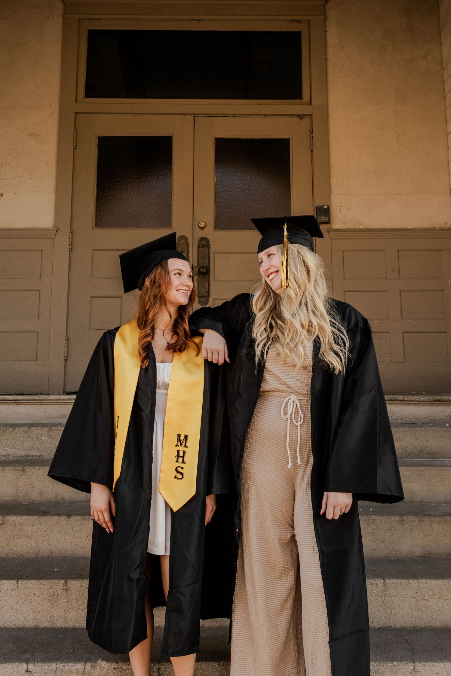 Graduation photos showing friends in black caps and gowns with gold honors stoles.