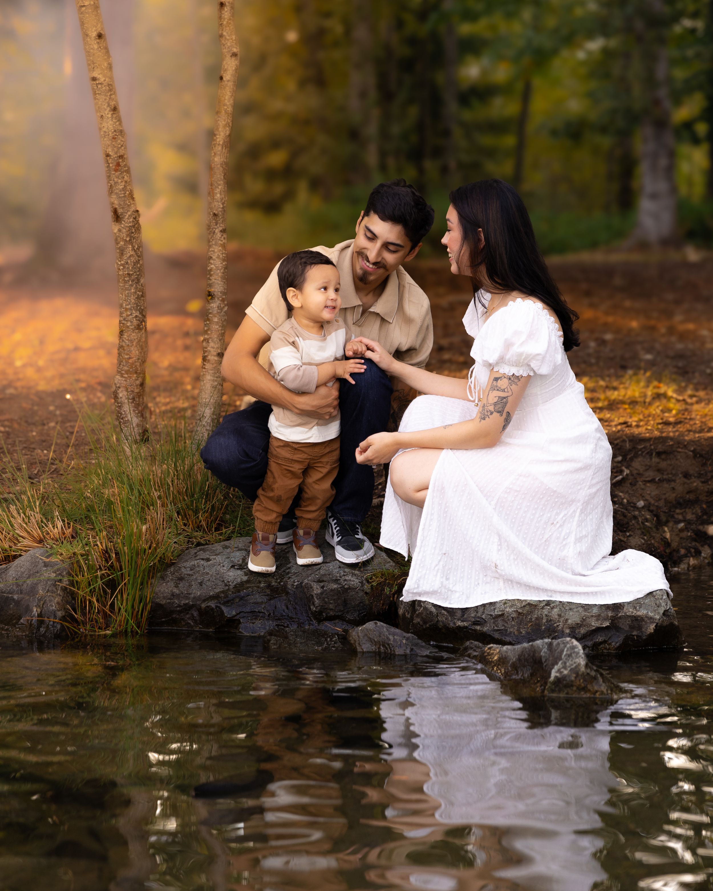 A family sit at the edge of Lake Tapps in Golden Hour during a family photography session in Washington.