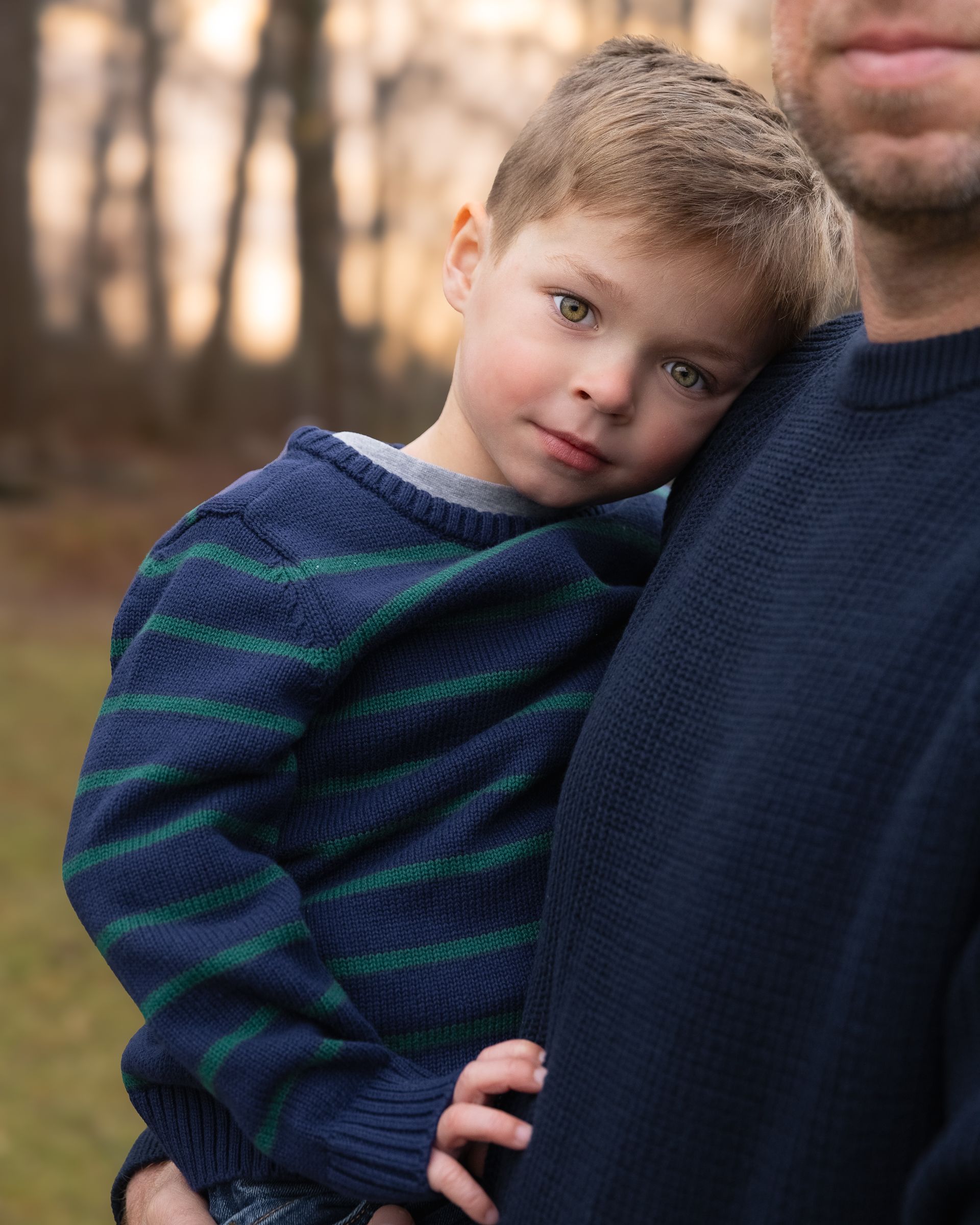 Dad holds son JJ at sunset during family session with Washington photographer Jess Bickel.