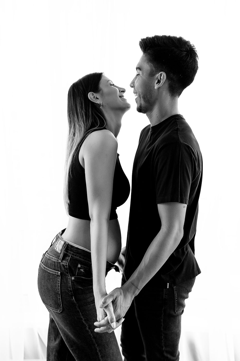 Black and white intimate portrait of couple sharing romantic moment.