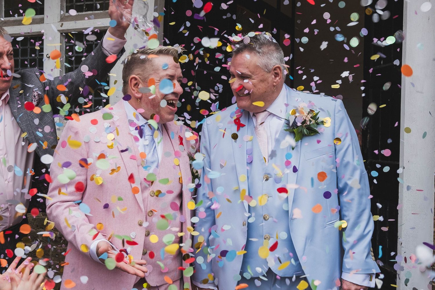 Gay couple showered with confetti at their wedding.
