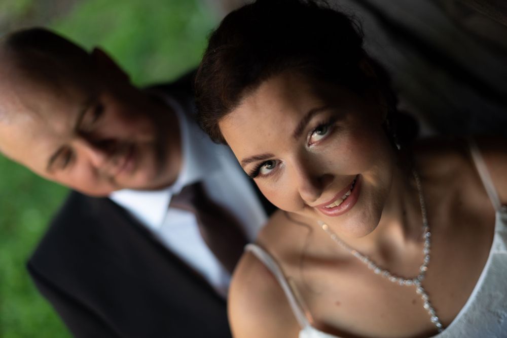 A romantic wedding portrait showing a couple in formal attire with soft focus effect.