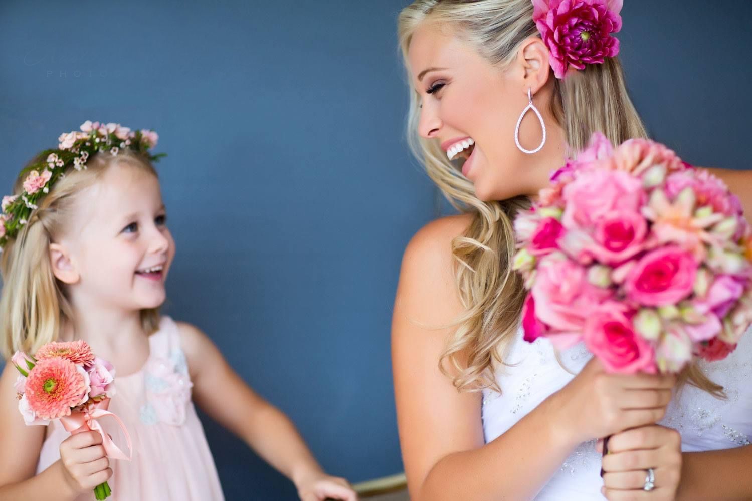 A joyful moment with pink flowers and laughter against a blue backdrop.