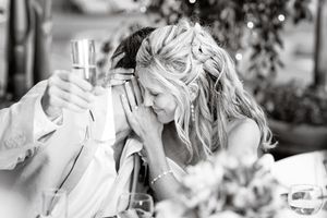 Candid black and white photo of wedding reception celebration.