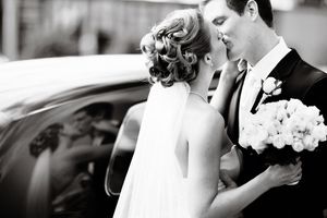 A classic black and white wedding photo with a bouquet of white flowers.