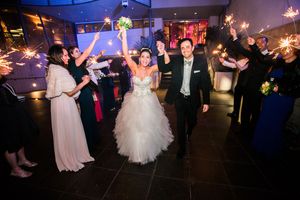 Wedding reception dance floor with sparklers creating magical ambiance as guests celebrate.