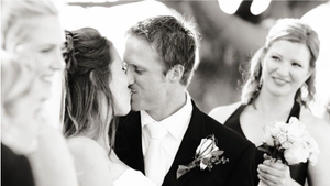 Intimate black and white candid shot of wedding couple's joyful interaction.