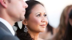 An elegant side profile portrait during a wedding ceremony.