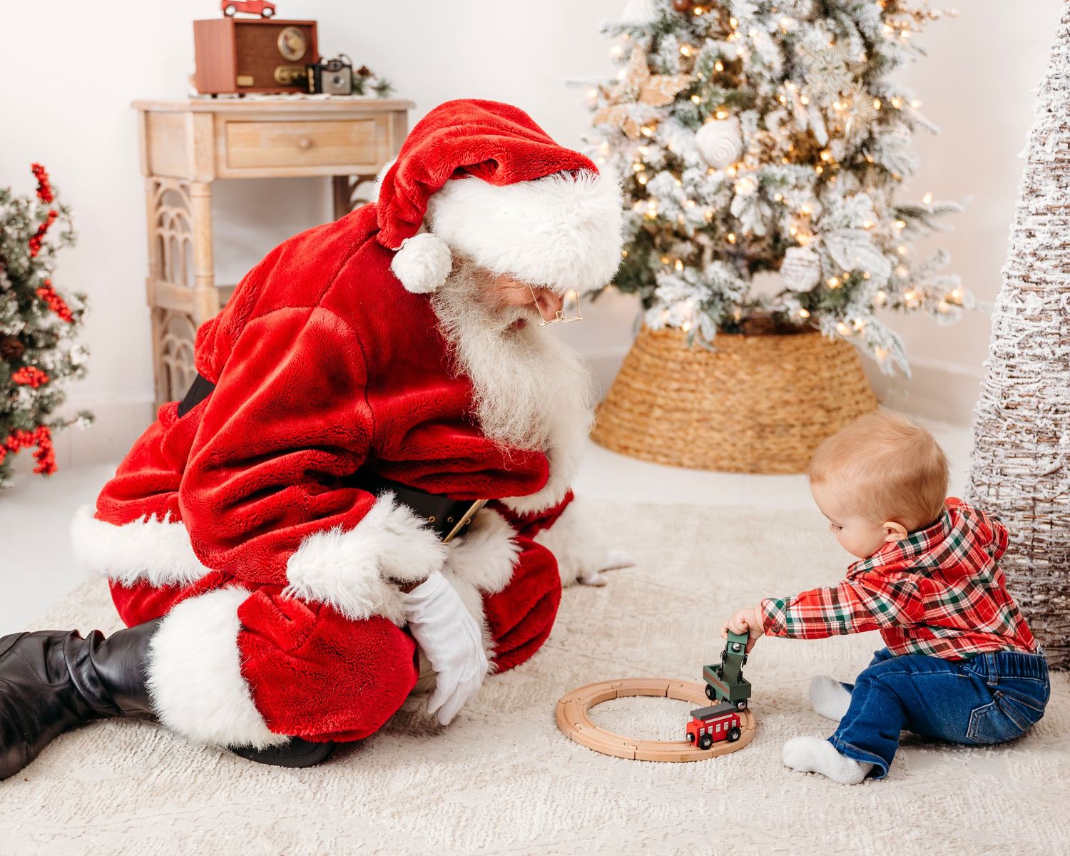 Christmas themed photography setup with decorated tree and cozy winter accessories.