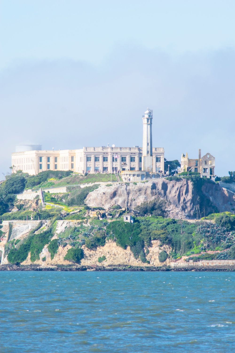 Alcatraz Island prison complex perched on rocky cliffs above San Francisco Bay.