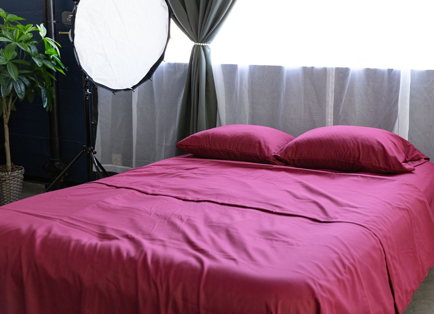 Bed prepared for boudoir photo shoot in Los Angeles photography studio.