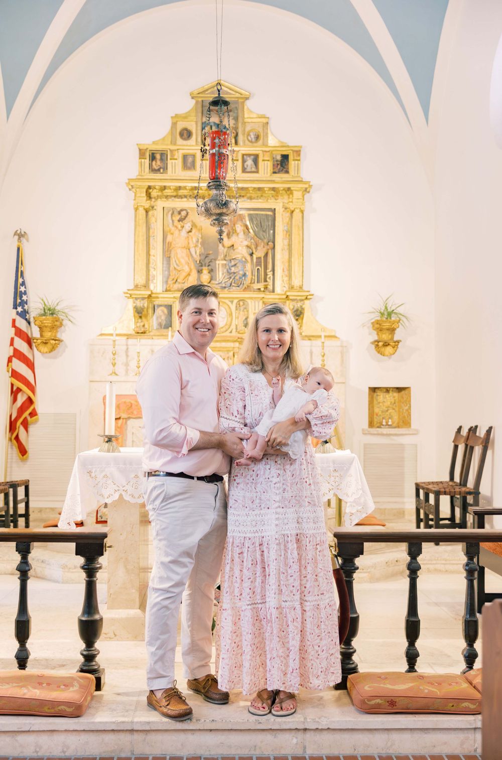 A church interior with ornate gold altar and American flag during a special ceremony.