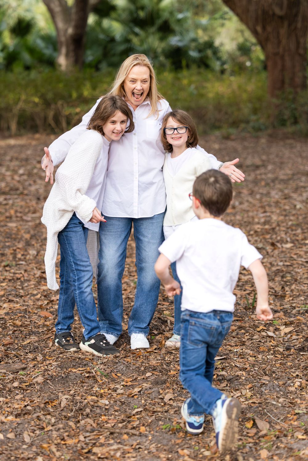 A playful family moment captured in a sequence of photos showing joyful interaction on fallen autumn leaves.