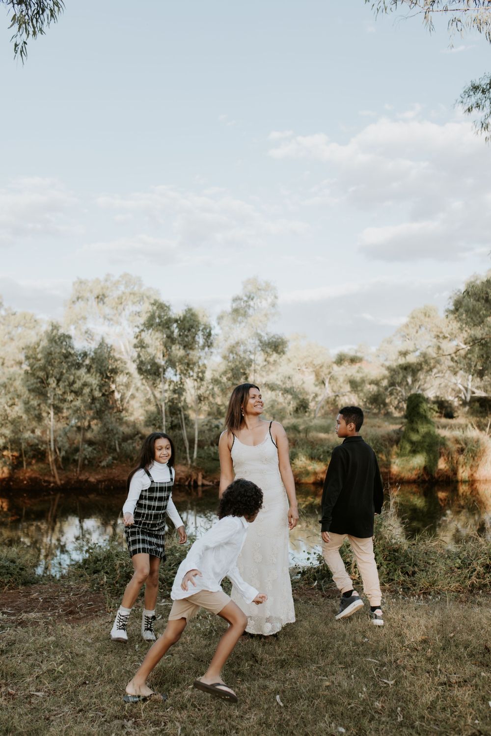 portrait of mother still as the children run around her in Mount Isa