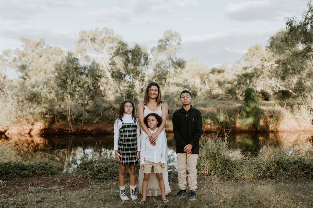 family of 4 pose for the camera in Mount Isa