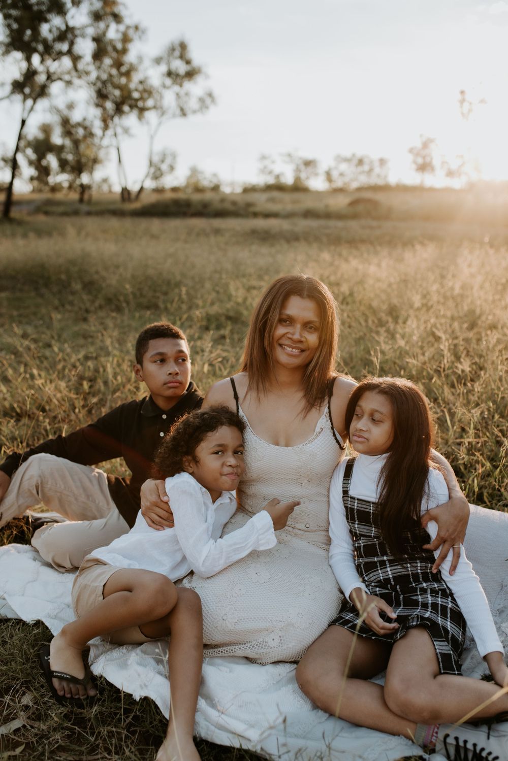 mother and children enjoying each other's company as the sunsets in Mount Isa
