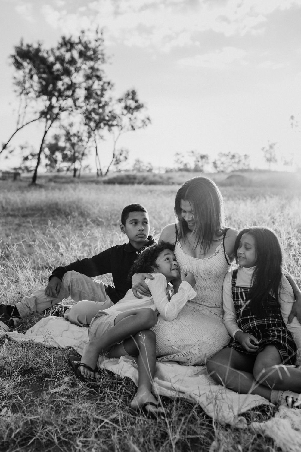 black and white photo of mother and her 3 babies