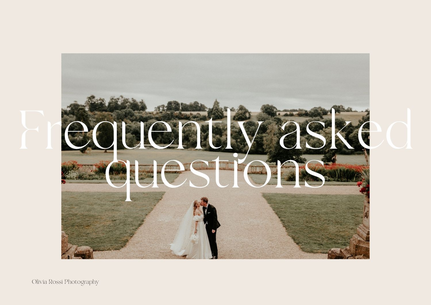 A wedding couple silhouetted against a scenic countryside backdrop walks hand in hand down a dirt path at sunset.