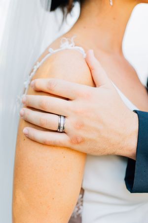 Close-up series of hands showing wedding rings and tender touches.