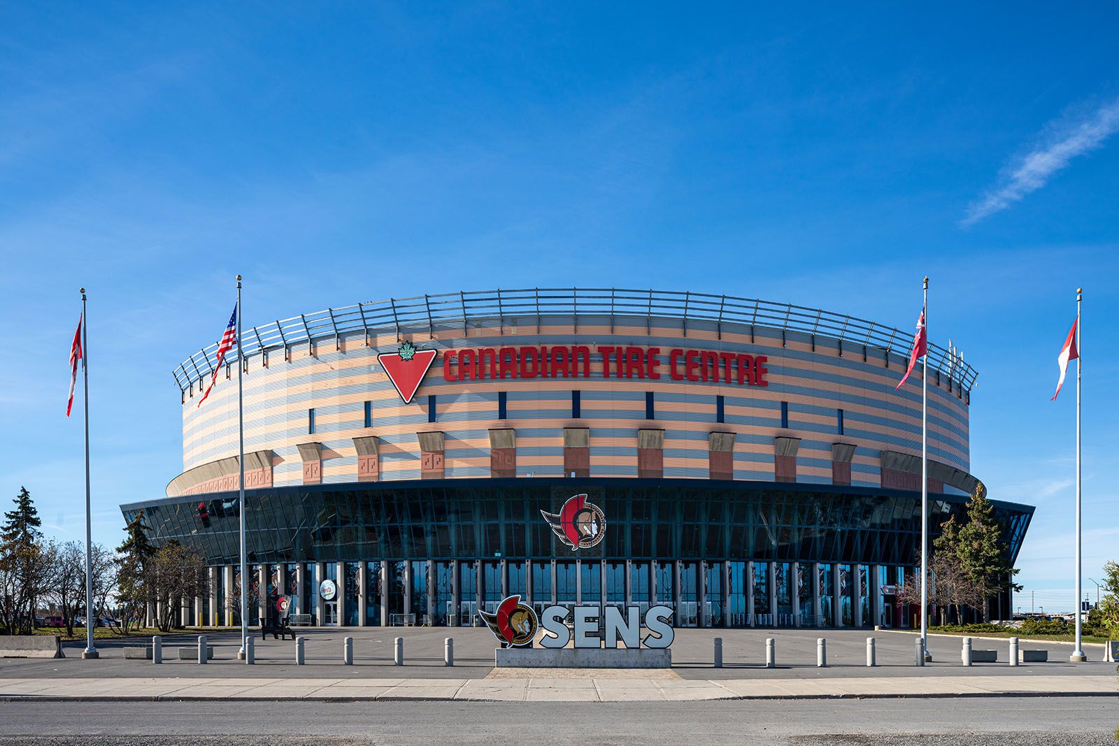 Symmetrical commercial architecture of Ottawa's Canadian Tire Centre, highlighting glass curtain walls and professional structural framing.