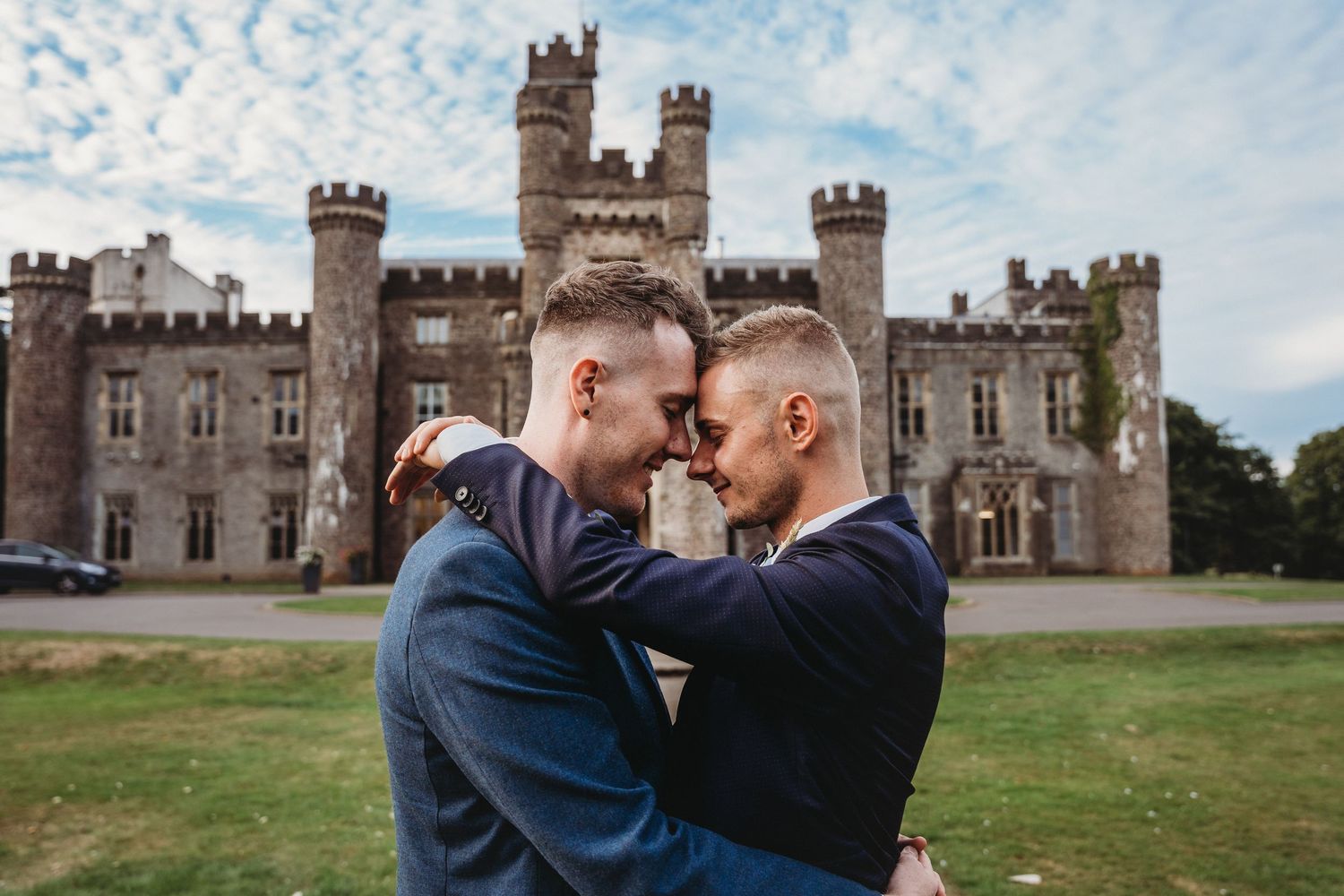 Romantic wedding couple shares intimate moments in a sunlit field.